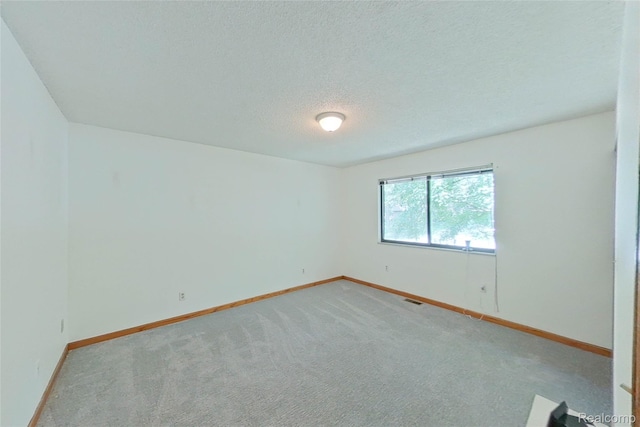 11589 Lombardy Ct, Pinckney, MI 48169 - unfurnished room featuring a textured ceiling and light colored carpet