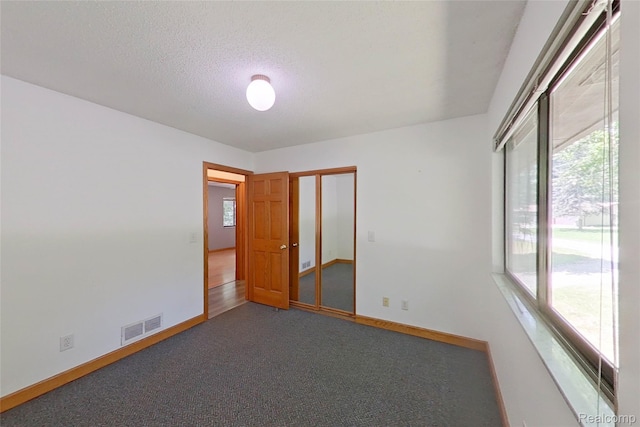 11589 Lombardy Ct, Pinckney, MI 48169 - carpeted spare room with baseboards and a textured ceiling