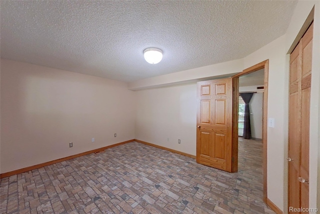 11589 Lombardy Ct, Pinckney, MI 48169 - spare room with brick patterned flooring and a textured ceiling