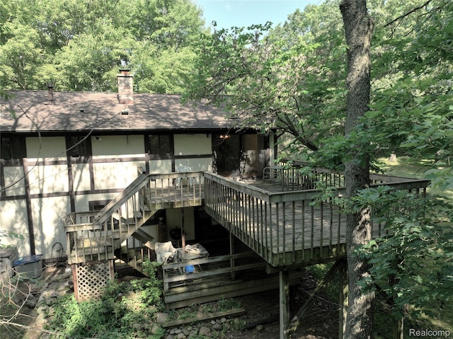 11589 Lombardy Ct, Pinckney, MI 48169 - rear view of property with a wooden deck, stairway, a chimney, and a shingled roof