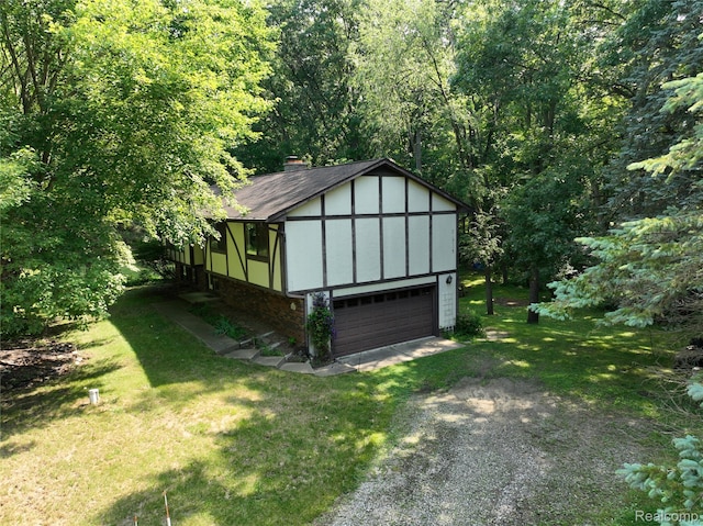 11589 Lombardy Ct, Pinckney, MI 48169 - view of outdoor structure with a garage, driveway, and a view of trees
