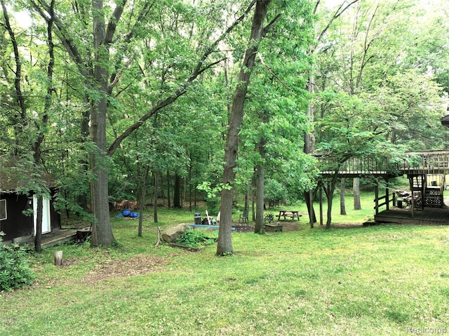 11589 Lombardy Ct, Pinckney, MI 48169 - view of grassy yard with a wooden deck