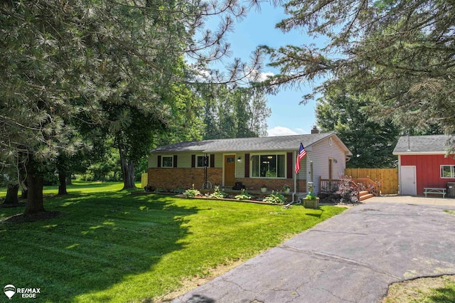 7226 Junction Rd, Frankenmuth, MI 48722 - single story home featuring brick siding, a chimney, and driveway