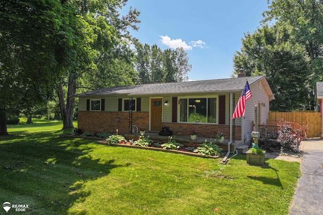 7226 Junction Rd, Frankenmuth, MI 48722 - view of front of house featuring brick siding, a chimney, and a porch