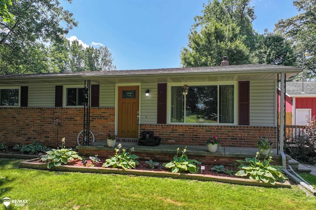 7226 Junction Rd, Frankenmuth, MI 48722 - view of front of house featuring brick siding, a porch, a front lawn, and a chimney