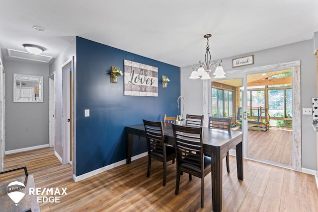 7226 Junction Rd, Frankenmuth, MI 48722 - dining room with wood finished floors and a chandelier