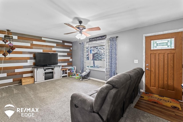 7226 Junction Rd, Frankenmuth, MI 48722 - carpeted living room with a ceiling fan and wood walls