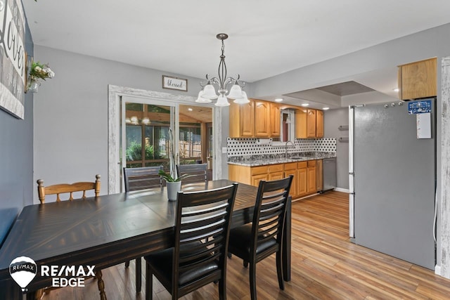 7226 Junction Rd, Frankenmuth, MI 48722 - dining space featuring a chandelier and light wood-style flooring