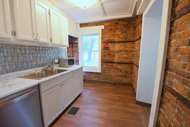 514 N Kalamazoo St, Paw Paw, MI 49079 - kitchen with stainless steel appliances, dark wood finished floors, brick wall, and white cabinetry