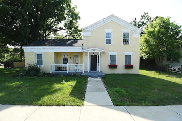 514 N Kalamazoo St, Paw Paw, MI 49079 - view of front of house with covered porch, brick siding, and a front yard