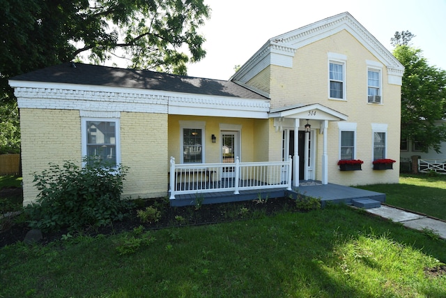514 N Kalamazoo St, Paw Paw, MI 49079 - view of front of house with brick siding, a porch, a front lawn, and roof with shingles
