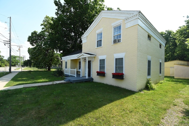 514 N Kalamazoo St, Paw Paw, MI 49079 - neoclassical / greek revival house with brick siding, a front yard, and a porch