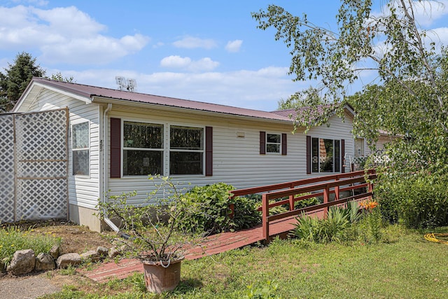 405 W Osborne Rd, Delton, MI 49046 - back of house with a metal roof and a wooden deck
