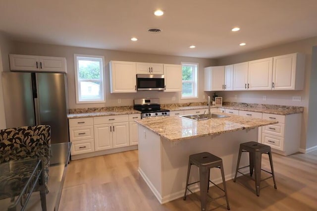 424 Doris St, Quincy, MI 49082 - kitchen featuring appliances with stainless steel finishes, healthy amount of natural light, white cabinetry, and recessed lighting