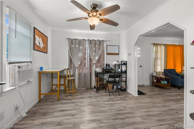 22355 Curie Ave, Warren, MI 48091 - dining space with wood finished floors, a ceiling fan, an office area, arched walkways, and crown molding
