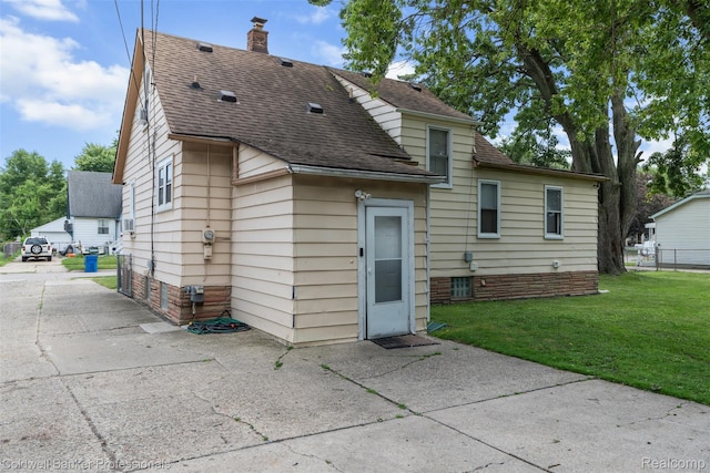 22355 Curie Ave, Warren, MI 48091 - rear view of house with a shingled roof and a chimney