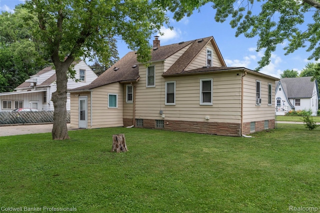 22355 Curie Ave, Warren, MI 48091 - rear view of house featuring a shingled roof, a chimney, and crawl space