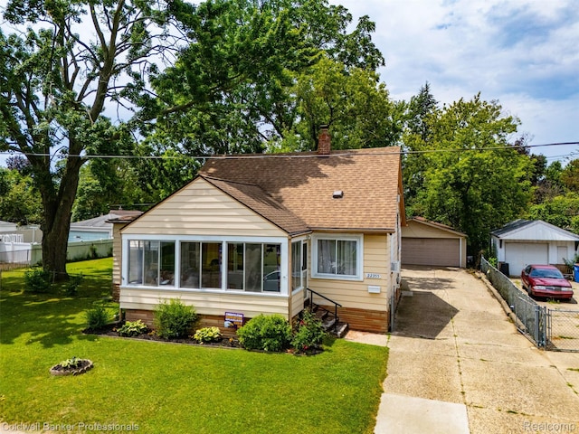 22355 Curie Ave, Warren, MI 48091 - bungalow featuring a detached garage, a shingled roof, a chimney, and an outdoor structure