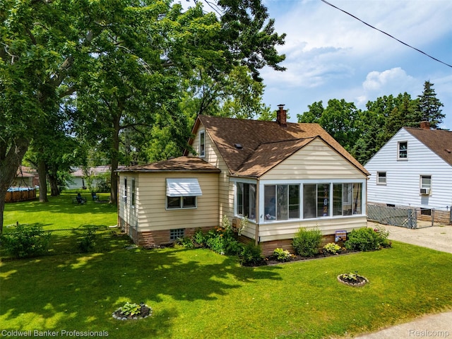 22355 Curie Ave, Warren, MI 48091 - back of property with a sunroom, a chimney, and roof with shingles