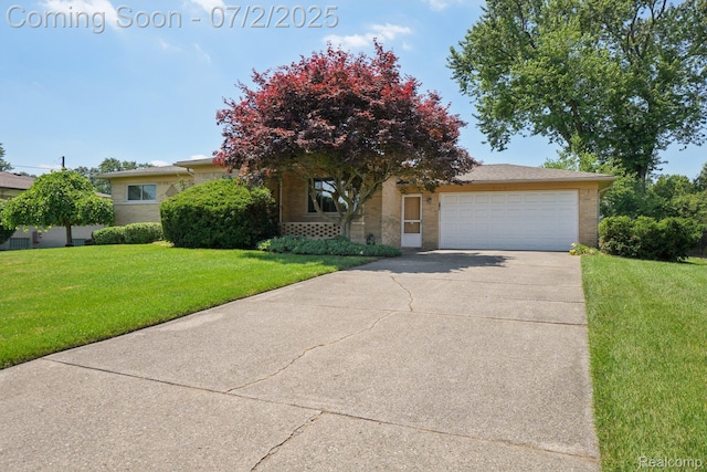 54829 Starlite Dr, Shelby Twp, MI 48316 - view of property hidden behind natural elements featuring brick siding, concrete driveway, a garage, and a front yard