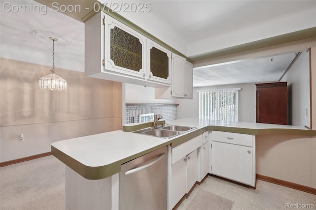 54829 Starlite Dr, Shelby Twp, MI 48316 - kitchen with dishwasher, a peninsula, white cabinets, light countertops, and decorative light fixtures