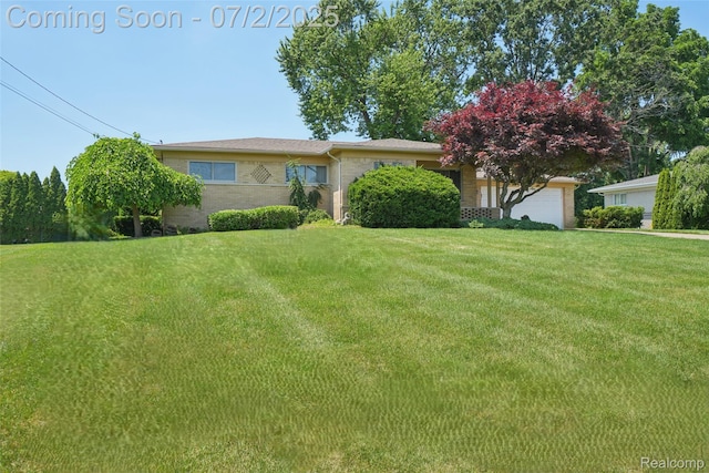 54829 Starlite Dr, Shelby Twp, MI 48316 - view of front facade featuring a front lawn, brick siding, and a garage