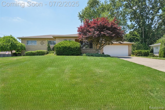 54829 Starlite Dr, Shelby Twp, MI 48316 - view of front facade featuring a front yard, brick siding, driveway, and an attached garage