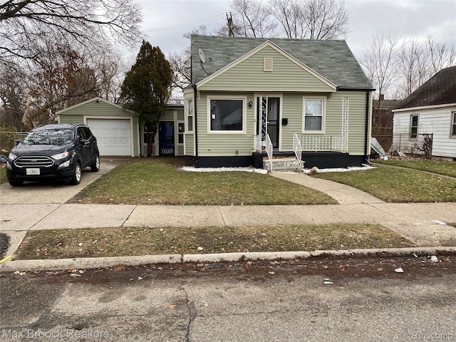 17486 Maine St, Detroit, MI 48212 - view of front of property featuring driveway, a detached garage, a front lawn, and a shingled roof