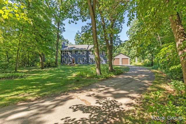 3268 Michele Ln, Hamilton, MI 49419 - colonial house featuring a garage, a chimney, a front yard, and an outdoor structure
