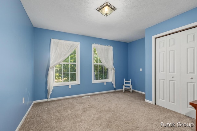 3268 Michele Ln, Hamilton, MI 49419 - unfurnished bedroom featuring carpet floors, a textured ceiling, and a closet