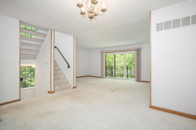 3841 Greenleaf Cir, Kalamazoo, MI 49008 - unfurnished living room with stairway, a chandelier, carpet floors, and a textured ceiling