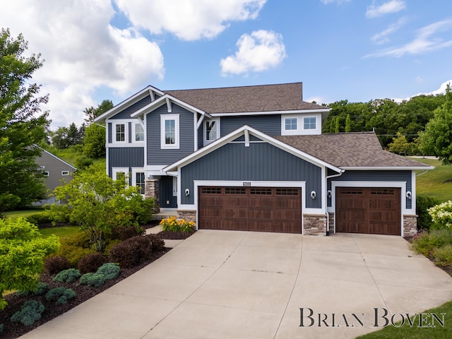 9633 Waterstone Dr, Byron Center, MI 49315 - craftsman house featuring board and batten siding, an attached garage, a shingled roof, driveway, and stone siding