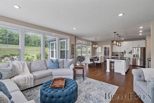 9633 Waterstone Dr, Byron Center, MI 49315 - living room featuring a chandelier, dark wood-style flooring, and recessed lighting