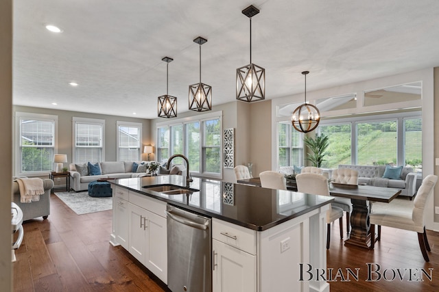 9633 Waterstone Dr, Byron Center, MI 49315 - kitchen with stainless steel dishwasher, open floor plan, dark countertops, dark wood finished floors, and recessed lighting