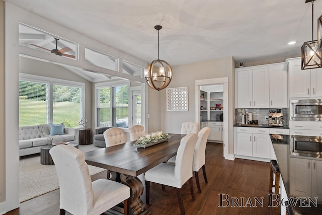 9633 Waterstone Dr, Byron Center, MI 49315 - dining space with a chandelier, dark wood finished floors, vaulted ceiling, recessed lighting, and a ceiling fan