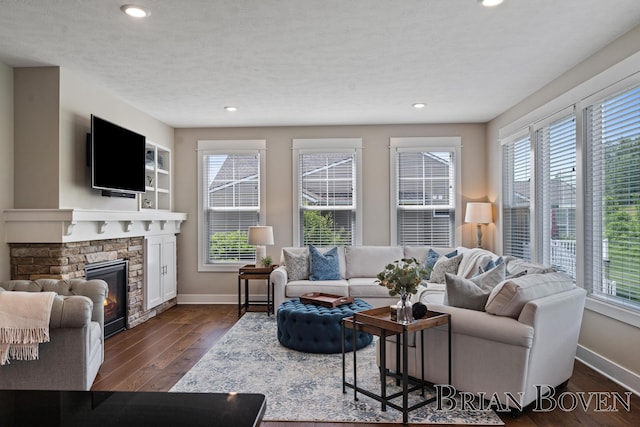 9633 Waterstone Dr, Byron Center, MI 49315 - living room featuring plenty of natural light, dark wood-style flooring, recessed lighting, and a stone fireplace
