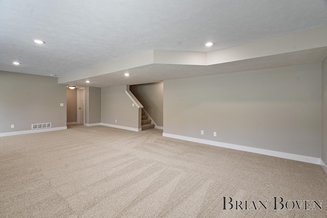 9633 Waterstone Dr, Byron Center, MI 49315 - finished basement featuring light colored carpet, recessed lighting, stairs, and a textured ceiling