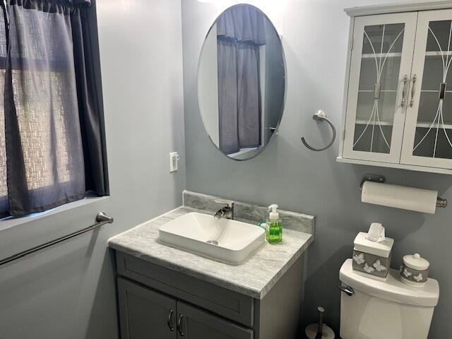 4969 N Highbridge Rd, Brethren, MI 49619 - bathroom featuring vanity and toilet