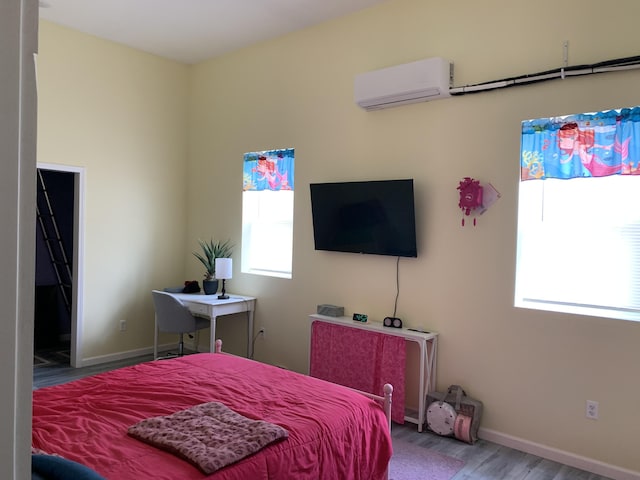 4969 N Highbridge Rd, Brethren, MI 49619 - bedroom with a wall mounted air conditioner, wood finished floors, and multiple windows