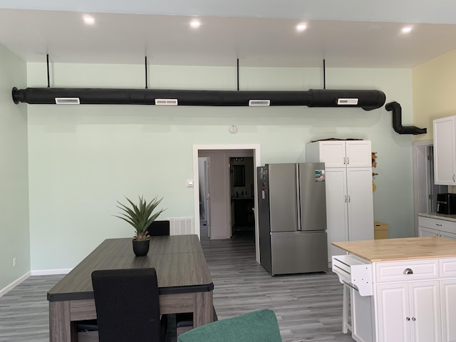 4969 N Highbridge Rd, Brethren, MI 49619 - kitchen with freestanding refrigerator, white cabinetry, light wood-type flooring, and recessed lighting
