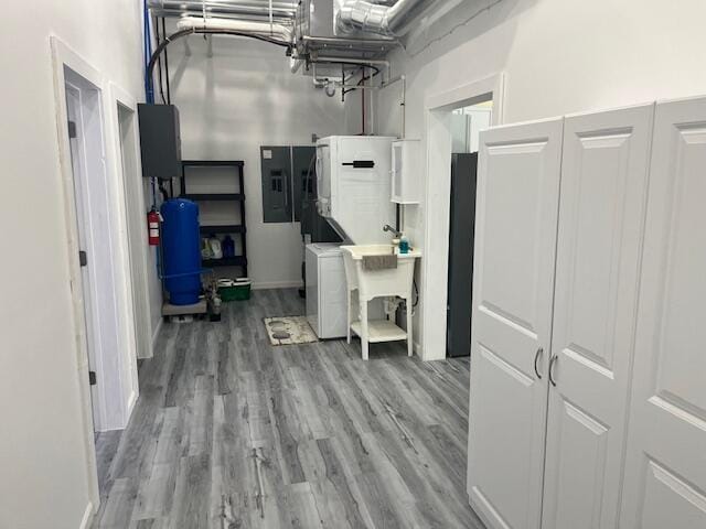 4969 N Highbridge Rd, Brethren, MI 49619 - hall with electric panel, washer / clothes dryer, and wood finished floors