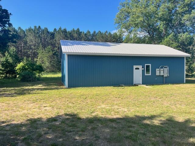 4969 N Highbridge Rd, Brethren, MI 49619 - view of pole building with a yard