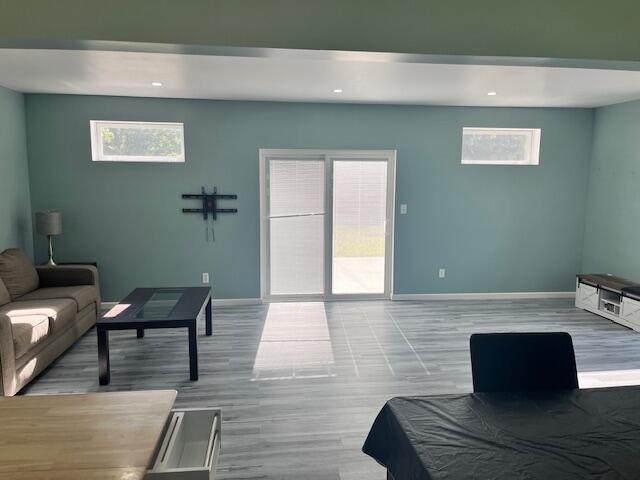 4969 N Highbridge Rd, Brethren, MI 49619 - living area featuring healthy amount of natural light, wood finished floors, and recessed lighting
