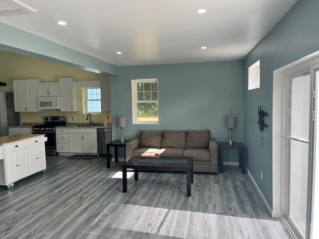 4969 N Highbridge Rd, Brethren, MI 49619 - living area with wood finished floors and recessed lighting