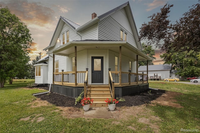 8008 W Sanilac Rd, Vassar, MI 48768 - farmhouse inspired home with covered porch, a chimney, and a front yard
