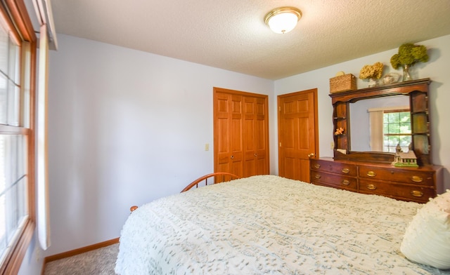 215 W State St, Coldwater, MI 49036 - carpeted bedroom featuring a closet and a textured ceiling