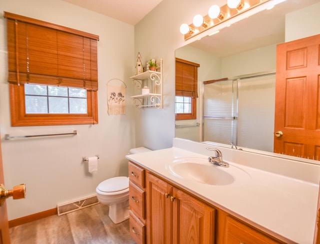 215 W State St, Coldwater, MI 49036 - full bathroom featuring vanity, a shower with door, and wood finished floors
