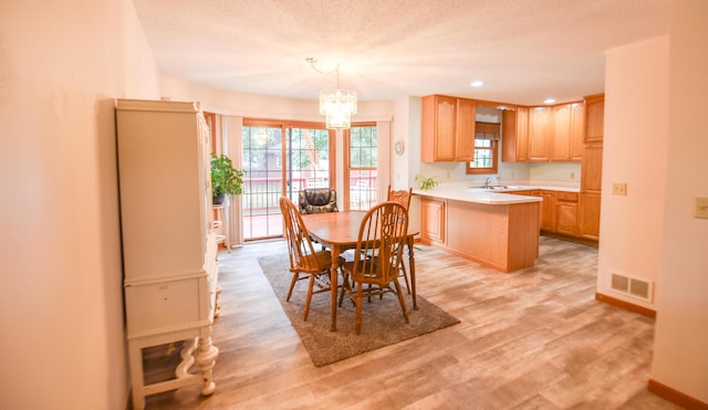215 W State St, Coldwater, MI 49036 - dining room with a chandelier, light wood-type flooring, recessed lighting, and a textured ceiling