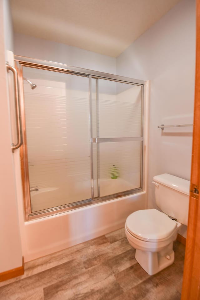 215 W State St, Coldwater, MI 49036 - bathroom with bath / shower combo with glass door and wood finished floors