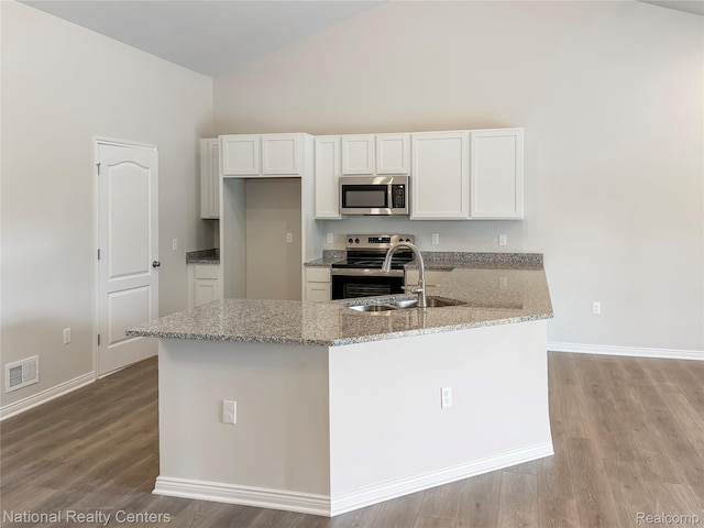 253 Devonshire Dr Unit 2, Lapeer, MI 48446 - kitchen with appliances with stainless steel finishes, high vaulted ceiling, white cabinets, light stone countertops, and light wood-style flooring